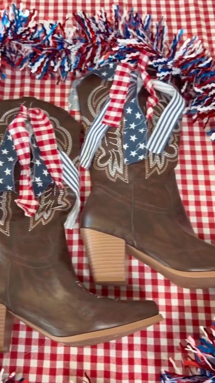 4th of July Outfits: 8 Festive Looks for Women 6 Brown cowboy boots decorated with patriotic ribbons on a red checkered tablecloth.