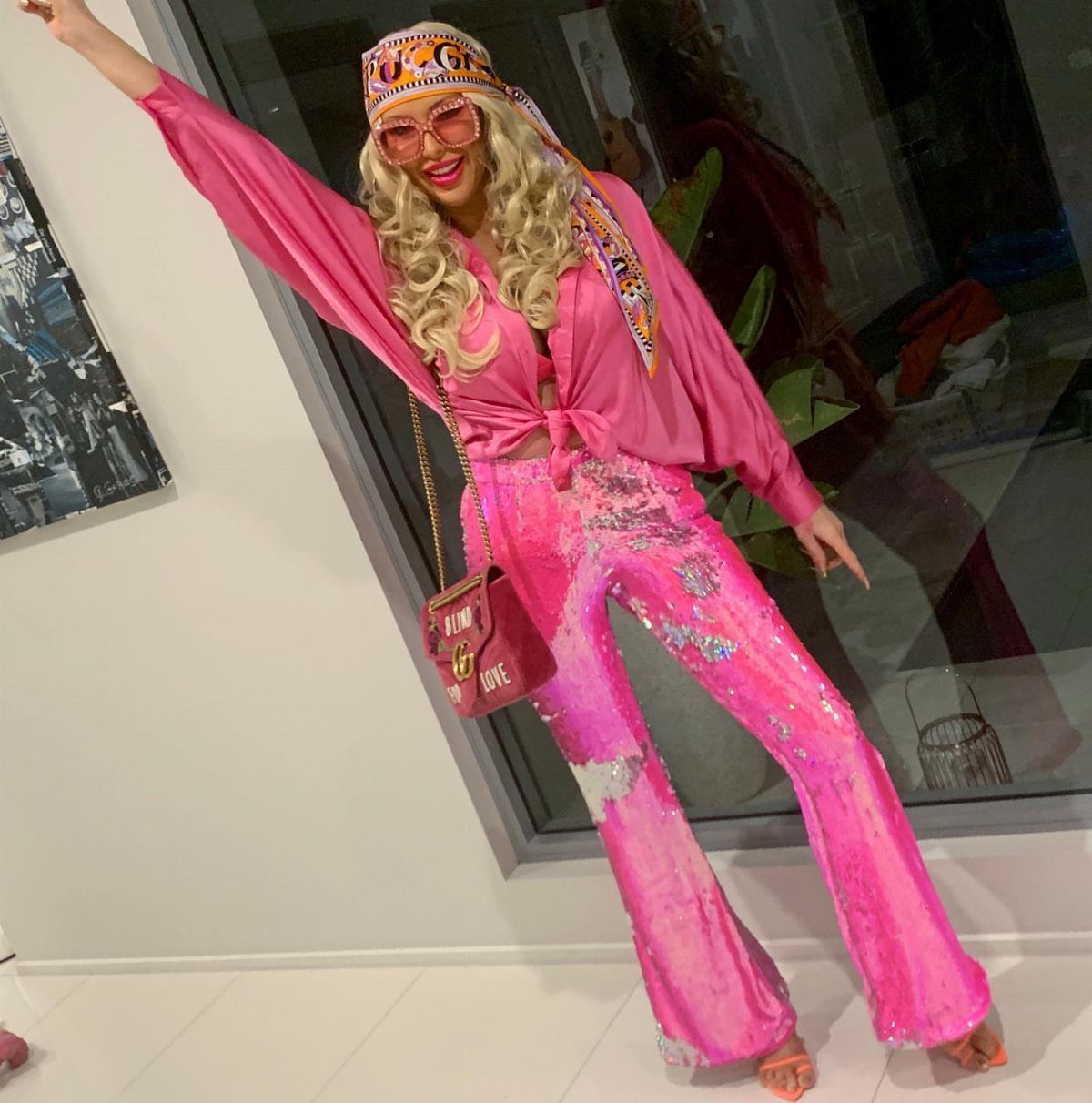 70's Inspired Outfits: 13 Retro Looks to Try Right Now 1 Person in pink sequined flared pants and matching top posing for a disco look.