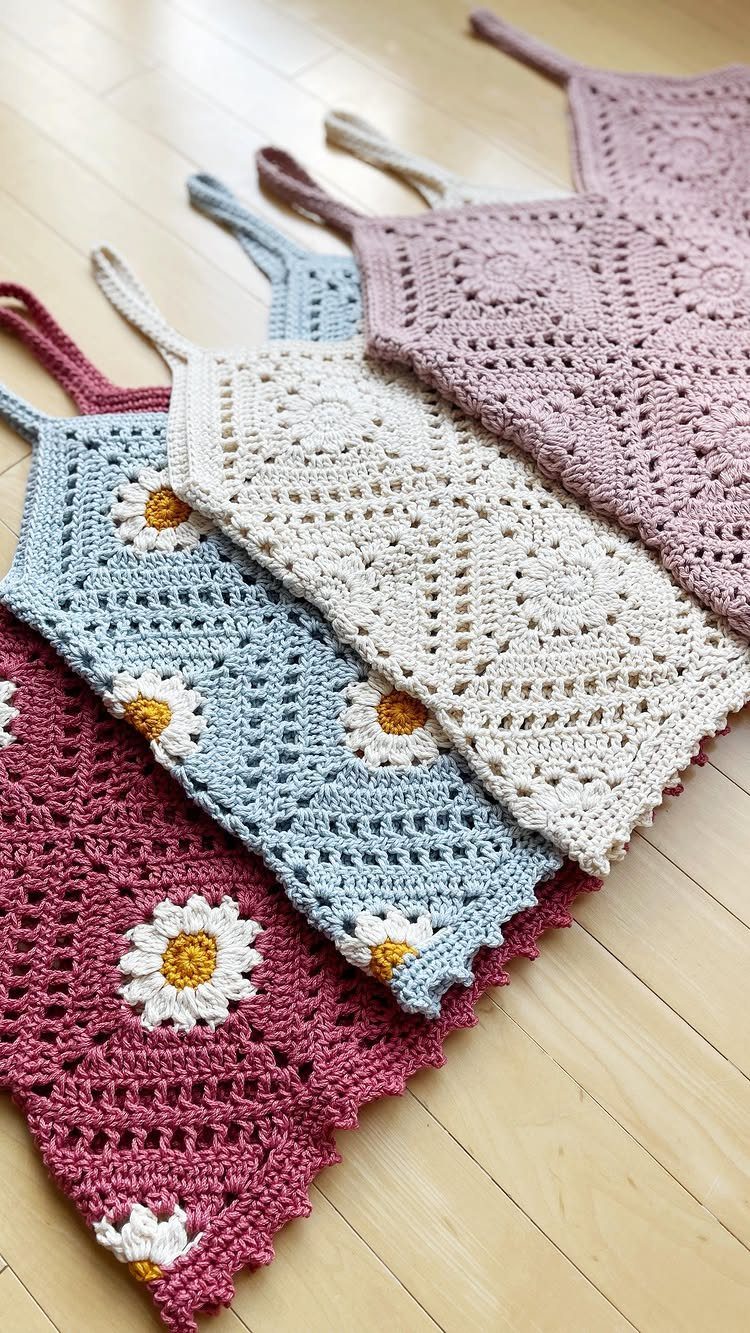 70's Inspired Outfits: 13 Retro Looks to Try Right Now 7 Four crochet tops in red, blue, cream, and purple on a wooden floor.