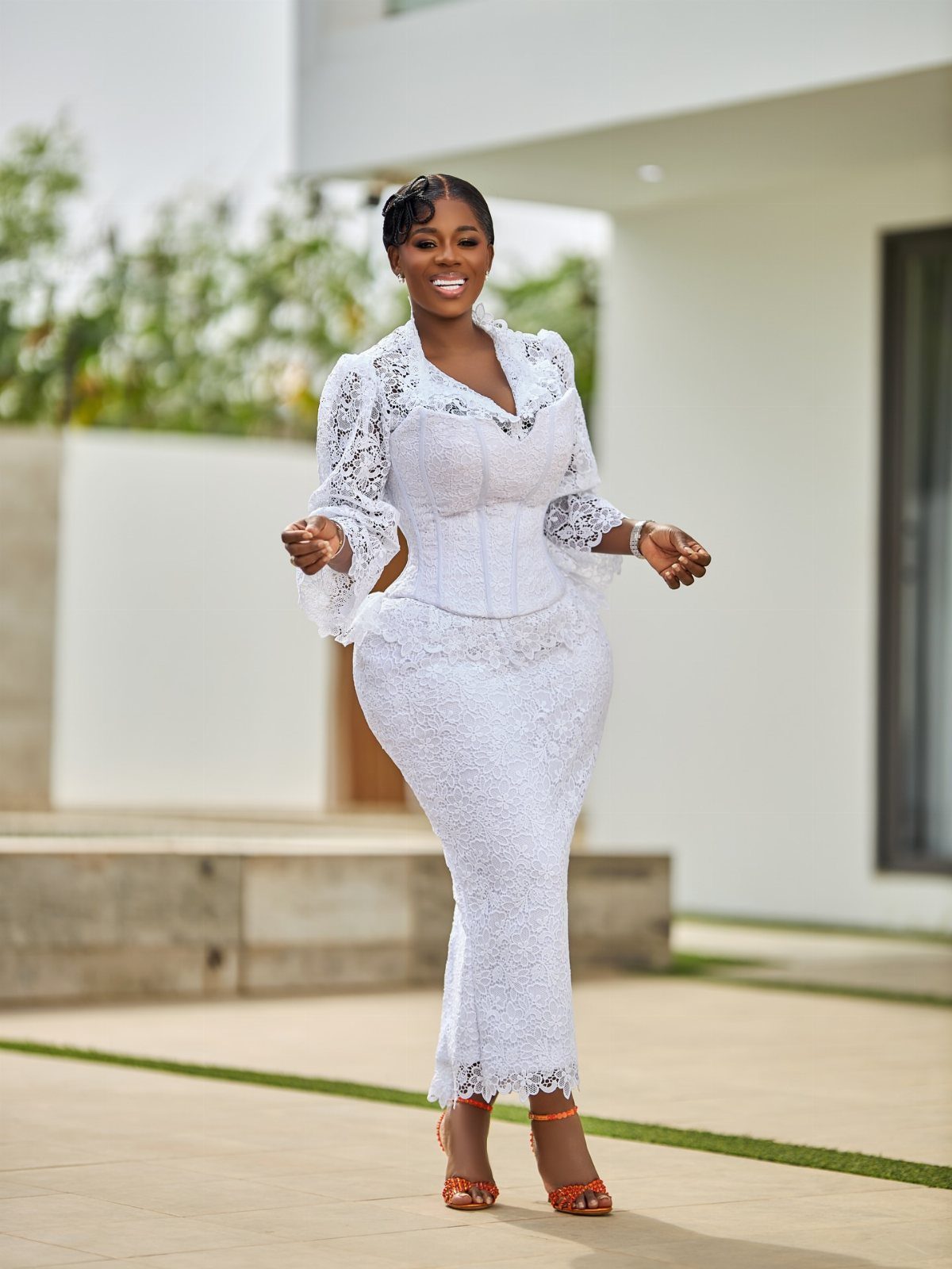 All White Party Outfits for Women: 10 Chic Ideas to Wear 4 Woman in a white lace dress and jacket with orange high-heeled sandals.