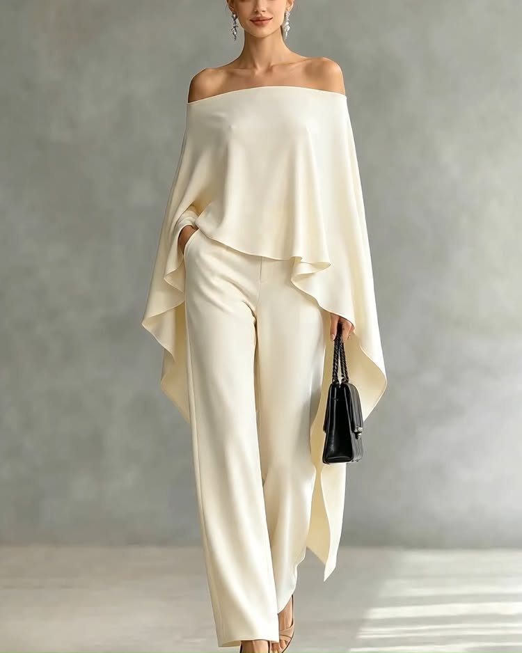 All White Party Outfits for Women: 10 Chic Ideas to Wear 10 Woman wearing a white off-the-shoulder top and wide-leg trousers with a black handbag.