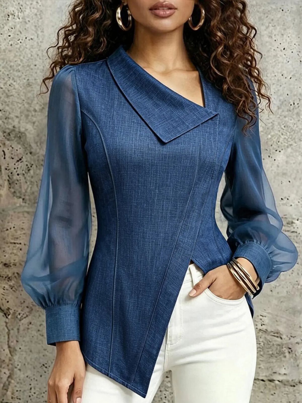 Apple Body Shape Outfits That Flatter Your Figure (9 Ideas) 8 Woman wearing a blue asymmetrical blouse with sheer sleeves and white trousers.