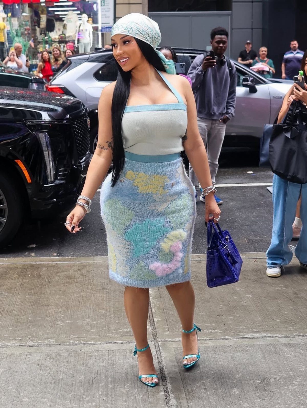 Cardi B Concert Outfits: 9 Bold Looks to Turn Heads 2 Cardi B in a light blue knit crop top and matching midi skirt.