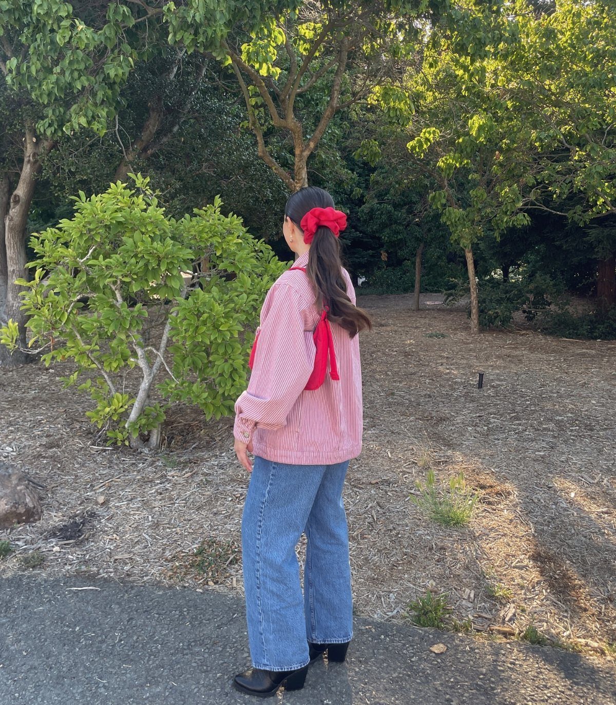 11 Comfortable Concert Outfits You'll Want to Wear in 2026 10 Person wearing striped shirt and wide-leg blue jeans standing in a wooded area