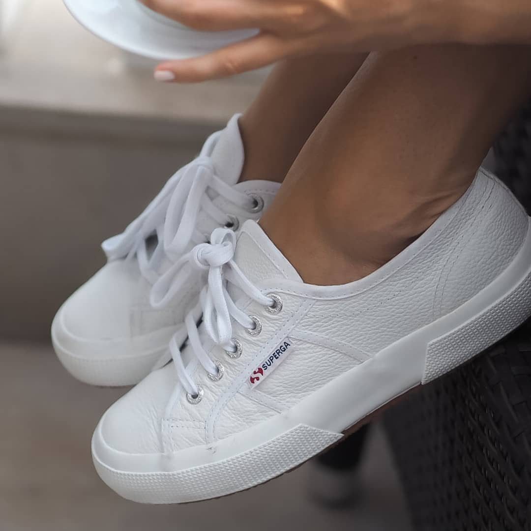 7 Country Club Outfits That Balance Style and Tradition 3 White canvas sneakers on a person's feet, showcasing a clean and comfortable style.
