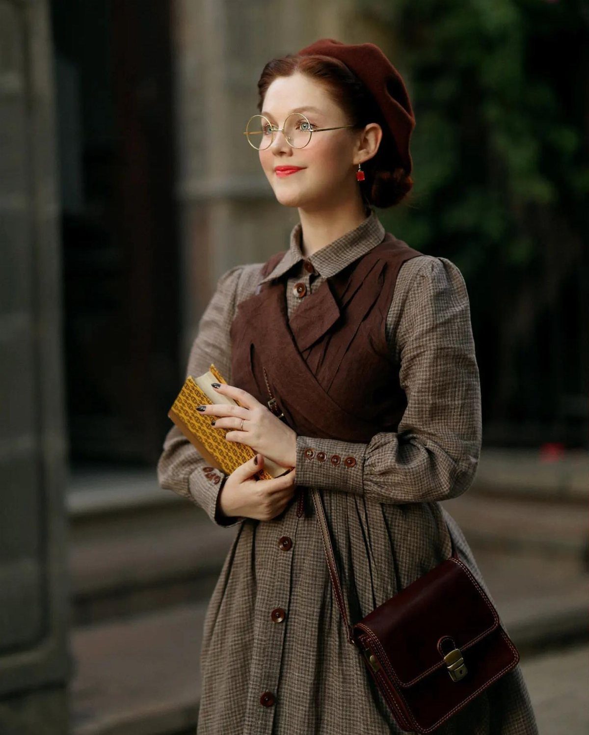 Dark Academia Outfits Female: 12 Ideas for Timeless Style 8 Woman in brown vintage dress and beret holding a book and leather satchel.