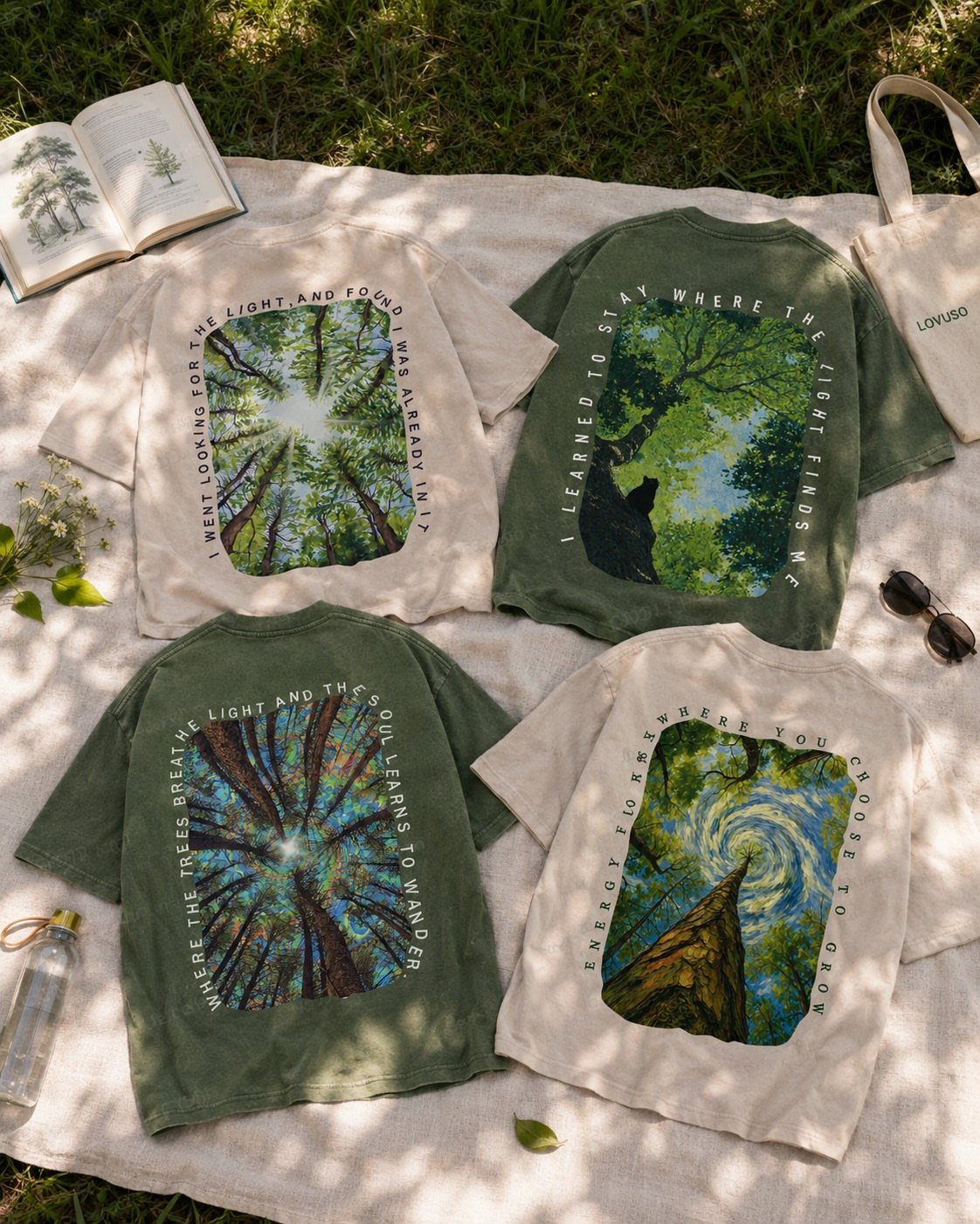 Dark Cottagecore Outfits: 8 Ideas from Dresses to Footwear 7 Four earthy toned t-shirts with forest graphics laid on a white outdoor blanket.