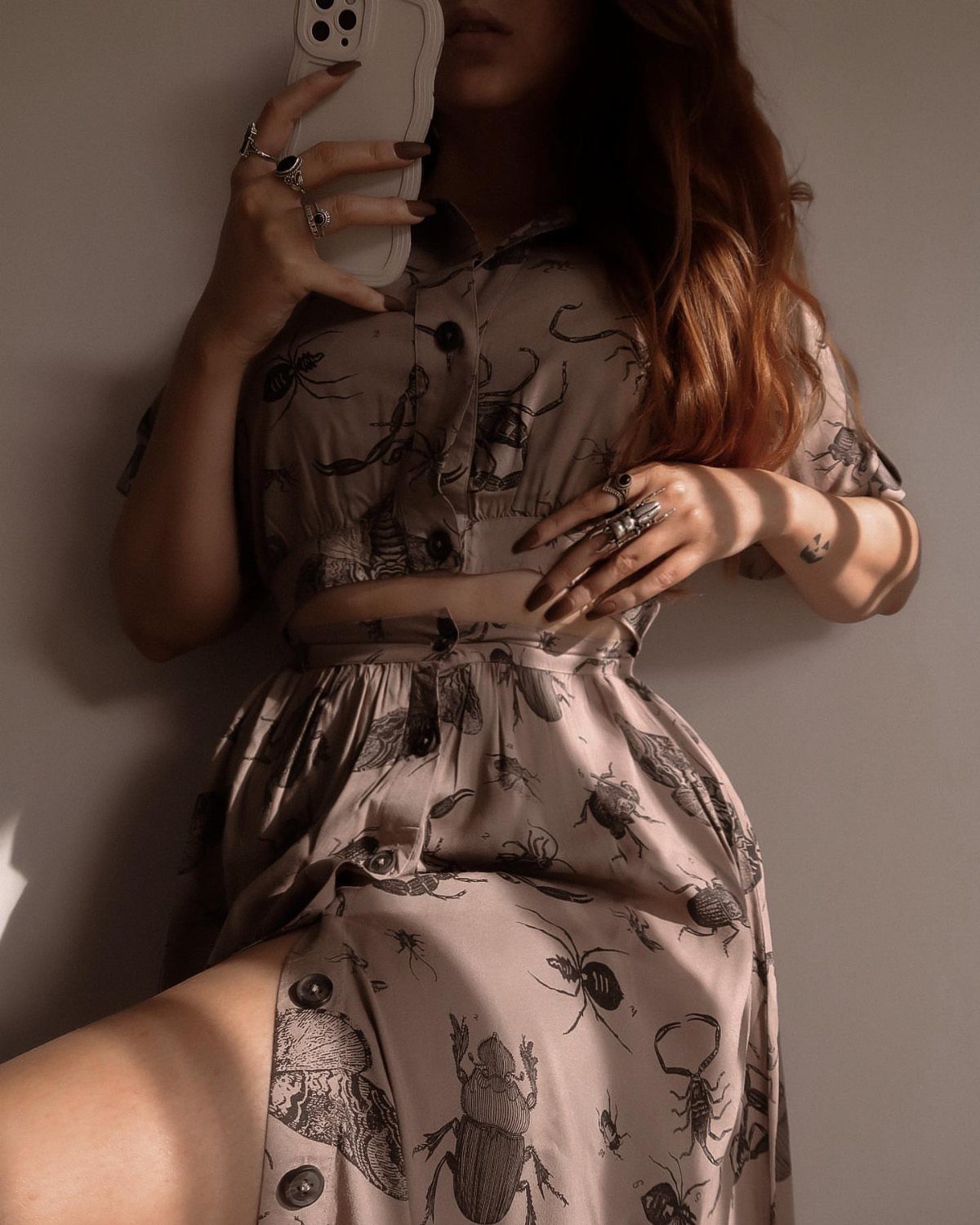 Dark Cottagecore Outfits: 8 Ideas from Dresses to Footwear 8 Person wearing a taupe two-piece outfit with black beetle and spider prints.