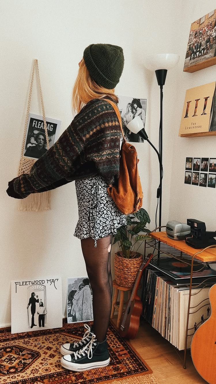 Dark Cottagecore Outfits: 8 Ideas from Dresses to Footwear 1 Person wearing a layered dark cottagecore outfit with a knit sweater and floral dress.