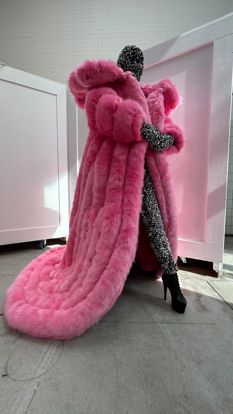 Drag Queen Outfits: 8 Bold Ideas for Your Next Performance 3 Person in a voluminous bright pink faux fur coat and silver sequined bodysuit.