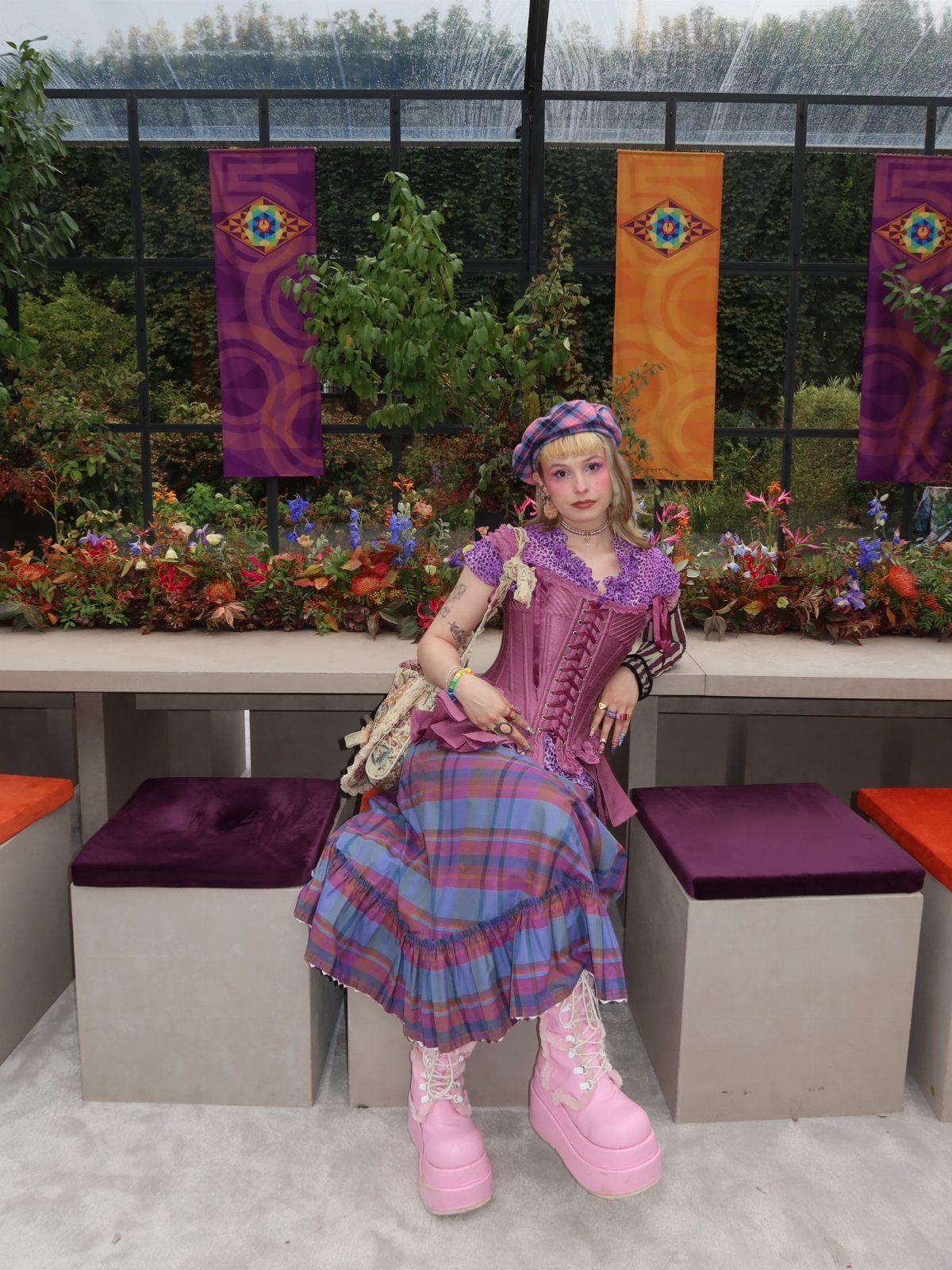 Effie Trinket Outfits: 10 Iconic Looks to Recreate 3 Person in a purple corset and plaid skirt wearing a purple headband.