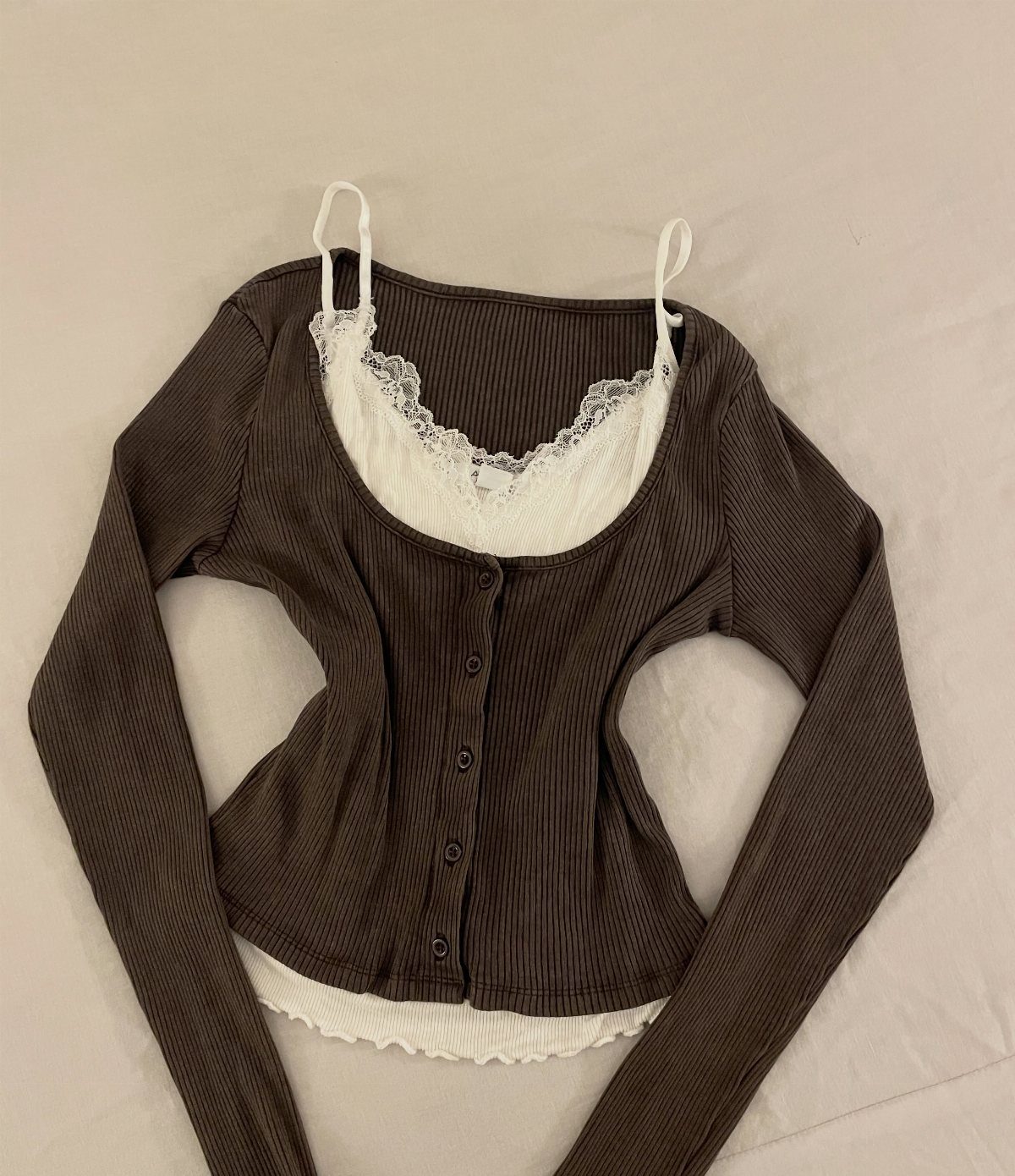 14 Elena Gilbert Outfits: Her Best Looks from the Show 4 Brown ribbed cardigan layered over a white lace camisole on a white background.