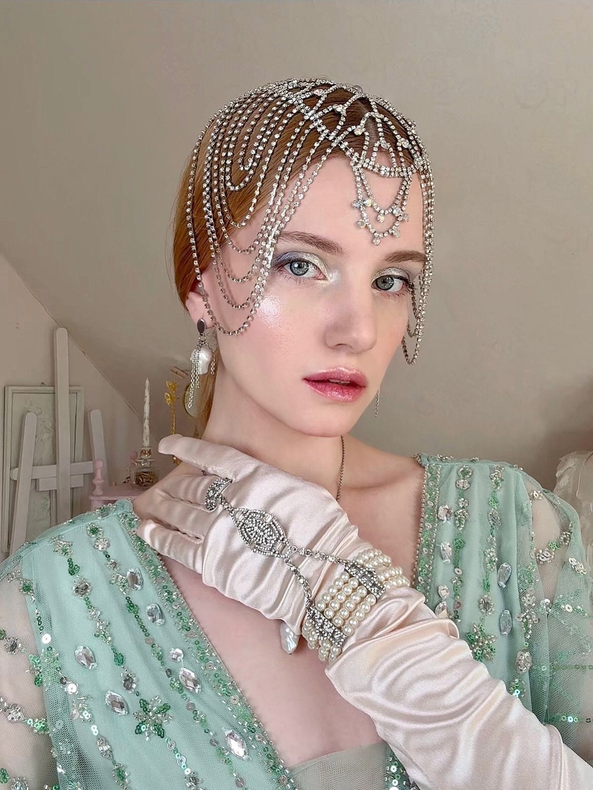 Great Gatsby Themed Outfits: 10 Ideas for Your Next Party 5 Woman in a mint green sequined flapper dress and beaded headpiece posing.
