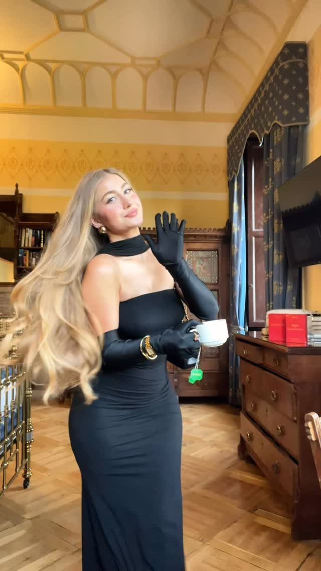 Great Gatsby Themed Outfits: 10 Ideas for Your Next Party 9 Woman in a black strapless gown and opera gloves holding a white teacup.