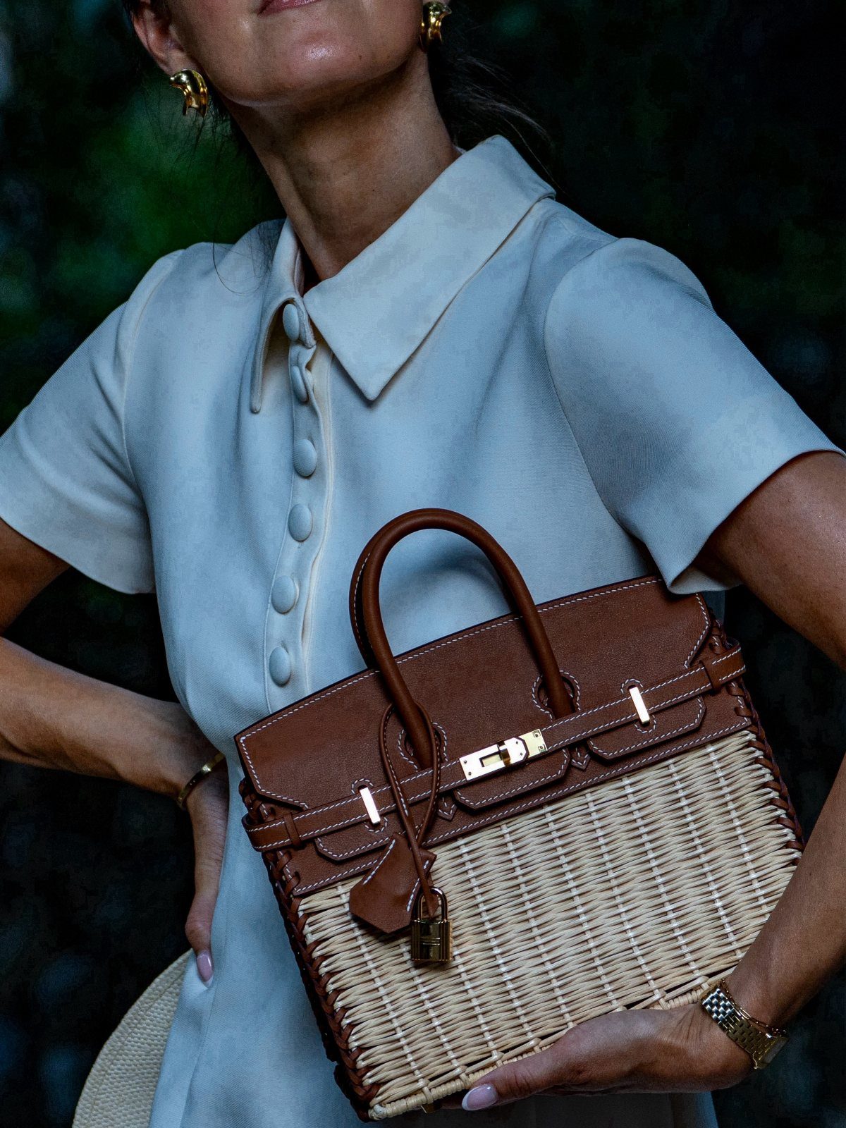 8 High Tea Outfits From Casual to Formal 8 Wicker and leather handbag held by a person in a light-colored dress.