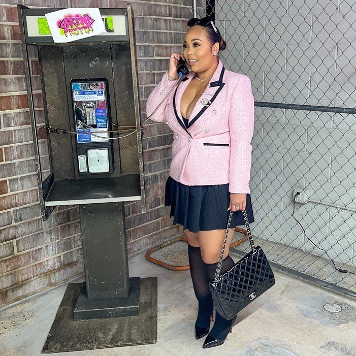 Hilary Banks Outfits: 12 Iconic Looks to Recreate Her Style 12 Woman in pink tweed blazer and black mini skirt using a payphone.