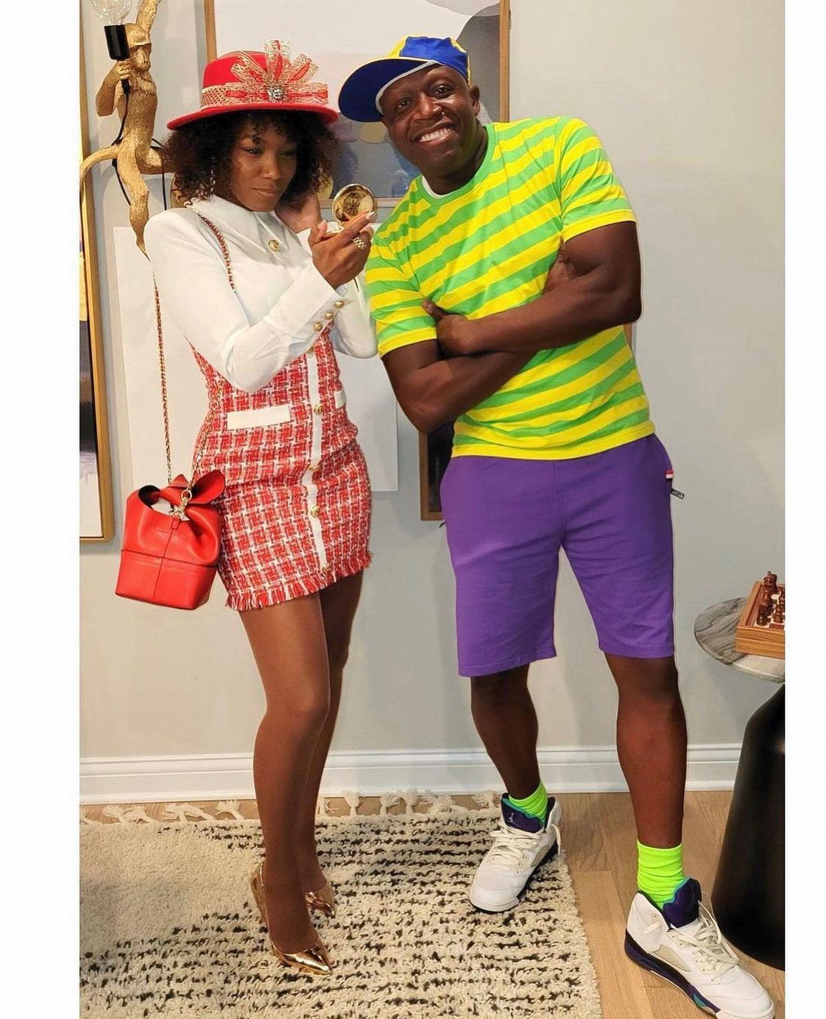 Hilary Banks Outfits: 12 Iconic Looks to Recreate Her Style 3 Woman in red plaid skirt and red hat standing with man in striped shirt.