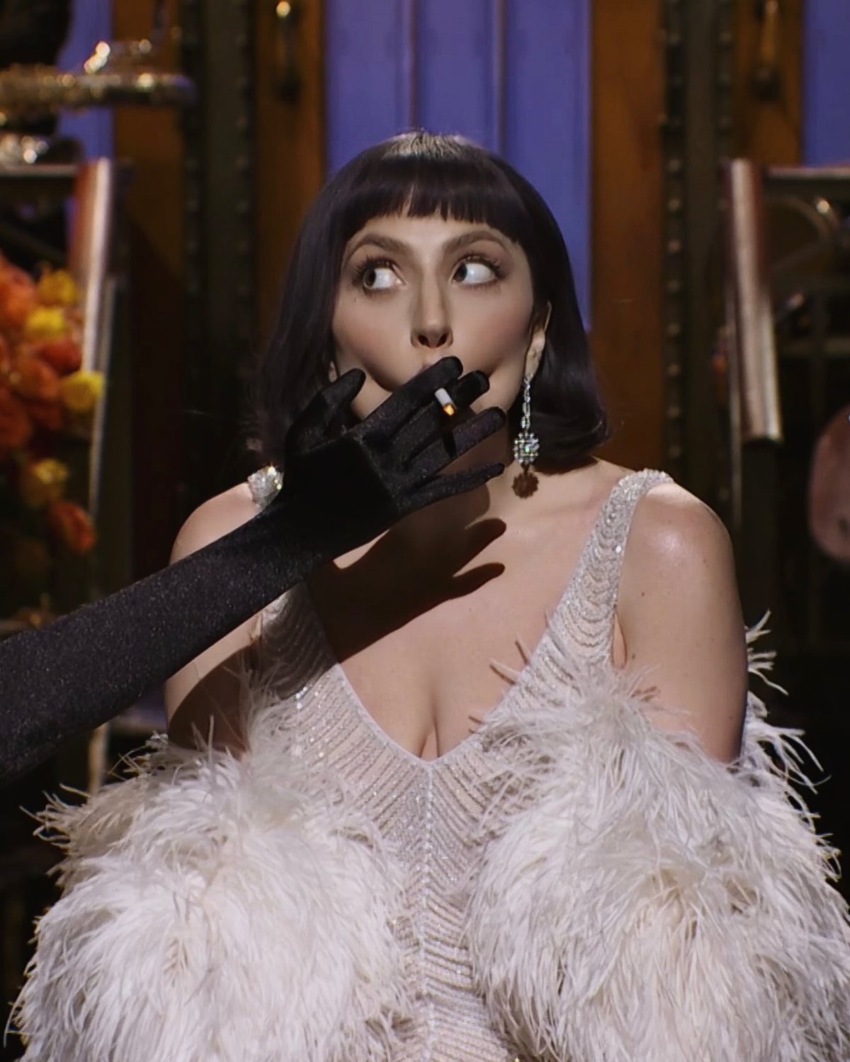 11 Lady Gaga Outfits That Defined Her Style Evolution 3 Lady Gaga in a white feathered gown with a long black glove.