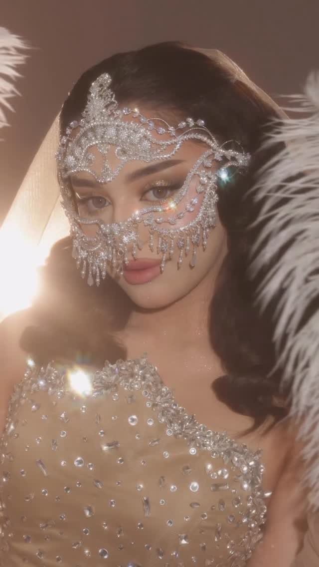 10 Stunning Masquerade Outfits for Women to Wear This Year 10 Woman wearing a sparkling rhinestone masquerade mask and a beaded gold evening gown.