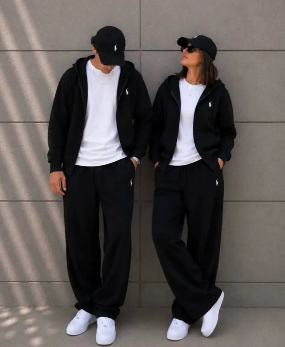 Matching Outfits for Couples: 6 Ideas from Gym to Formal 4 Couple wearing matching black loungewear sets with white t-shirts and white sneakers.