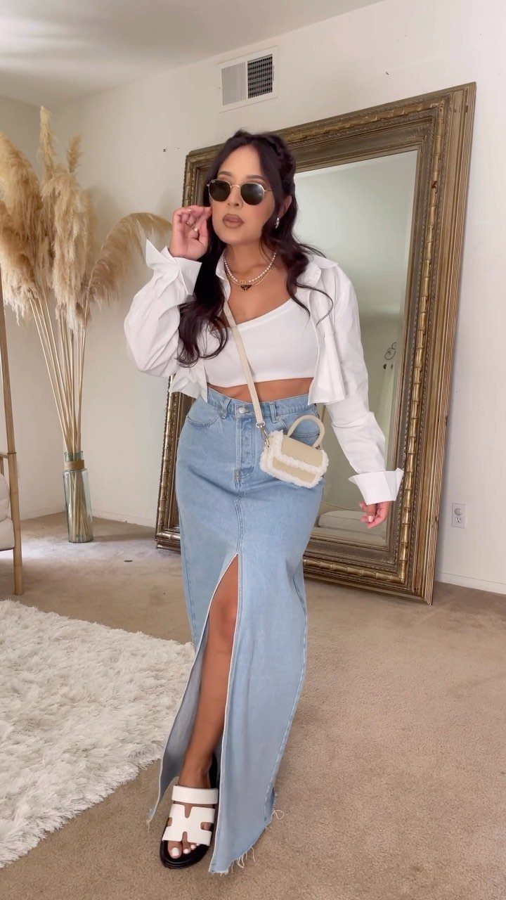 12 Maxi Skirt Outfits to Wear All Year in 2026 4 Woman wearing a denim maxi skirt with a white tube top and cropped shirt.
