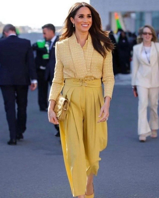Meghan Markle Outfits: 17 Ideas from Tailored to Casual 12 Meghan Markle wearing a yellow textured blazer and matching high-waisted wide-leg trousers.