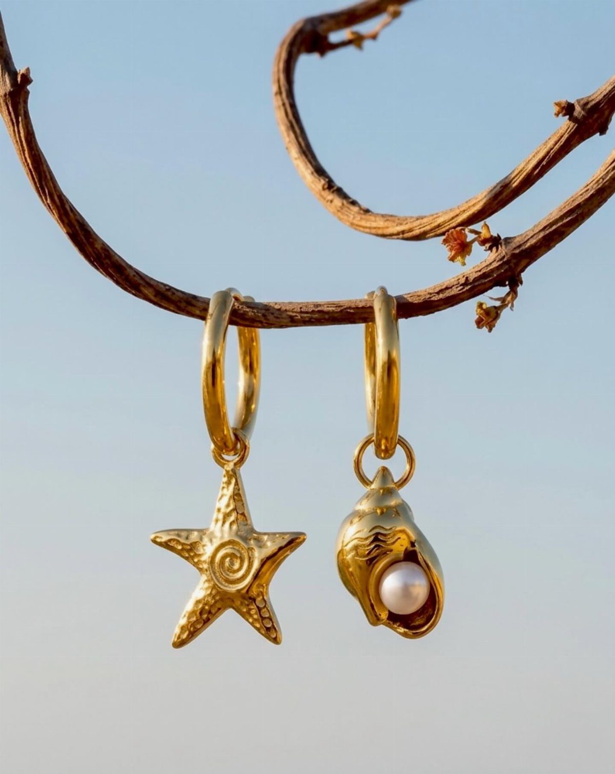 Mermaid Inspired Outfits for Your 5 Most Magical Looks 2 Gold starfish and seashell earrings with a pearl hanging from a thin branch.
