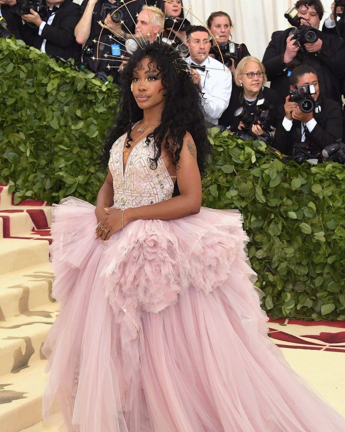 Met Gala Outfits 2026: 10 Looks That Stole the Night 10 Woman in a pink tulle gown and golden halo headpiece at the Met Gala.