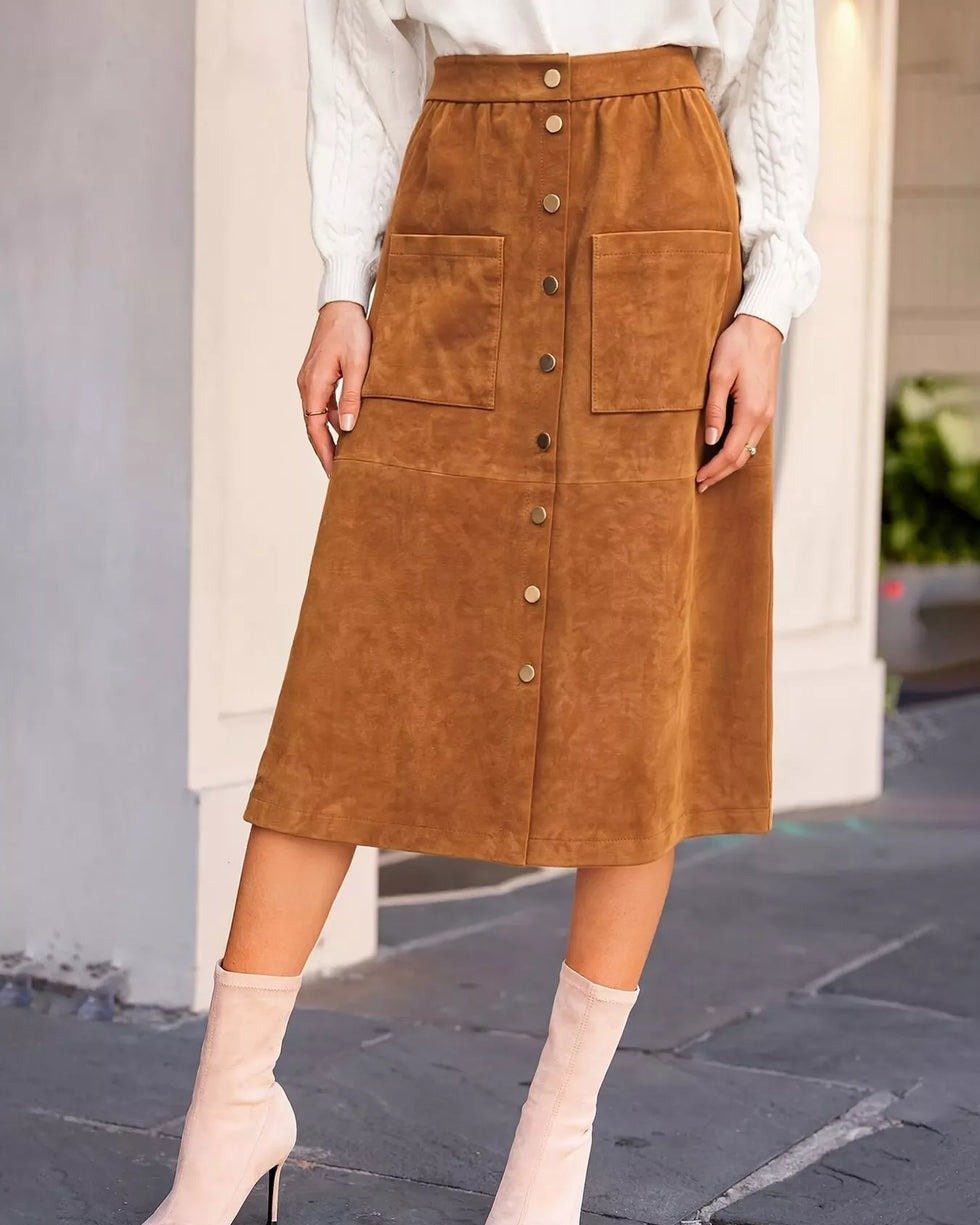 12 Midi Skirt Outfits for Every Season and Style 12 Brown suede midi skirt with buttons paired with a white top and beige boots.