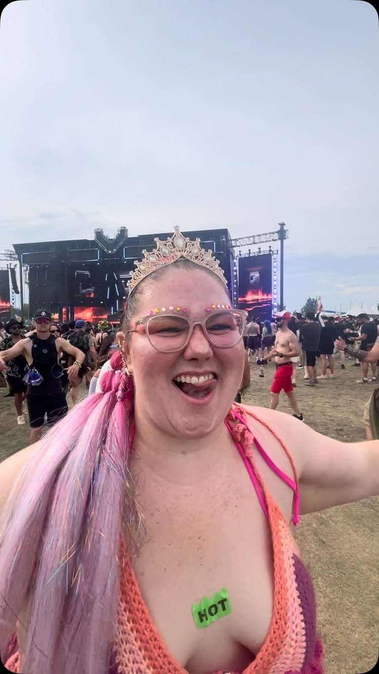 Plus Size Festival Outfits: 9 Looks You'll Want to Wear 8 Smiling plus-size woman in a colorful crochet top and tiara at a festival.