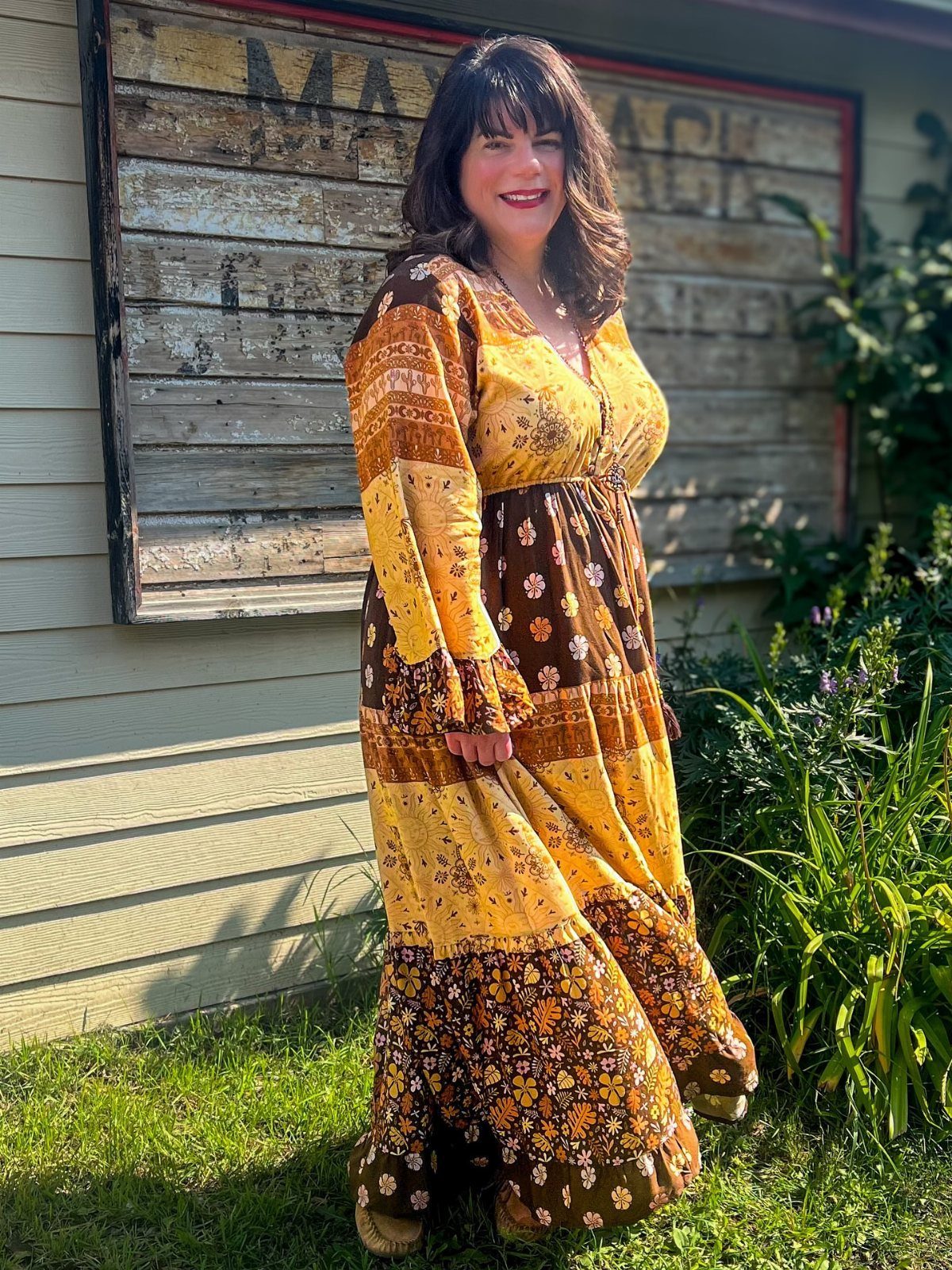 Plus Size Festival Outfits: 9 Looks You'll Want to Wear 5 Plus size woman wearing a long yellow and brown floral boho maxi dress outdoors