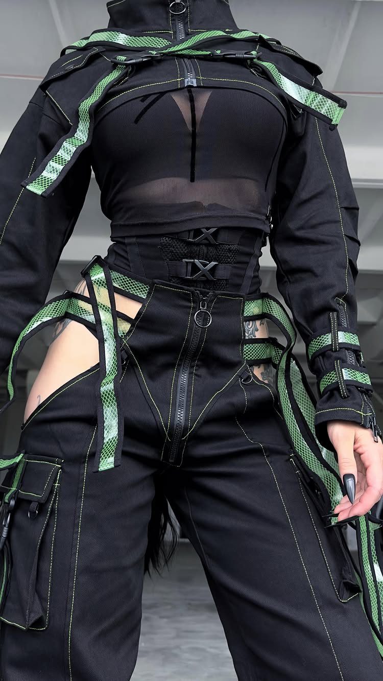 8 Plus Size Rave Outfits That Bring the Energy 7 Person in black cyberpunk rave outfit with neon green straps and cargo pants.