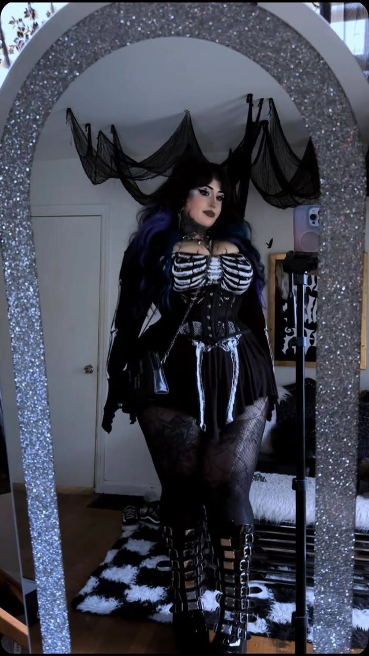 8 Plus Size Rave Outfits That Bring the Energy 6 Plus-size woman in a gothic rave outfit with skeleton print and platform boots.
