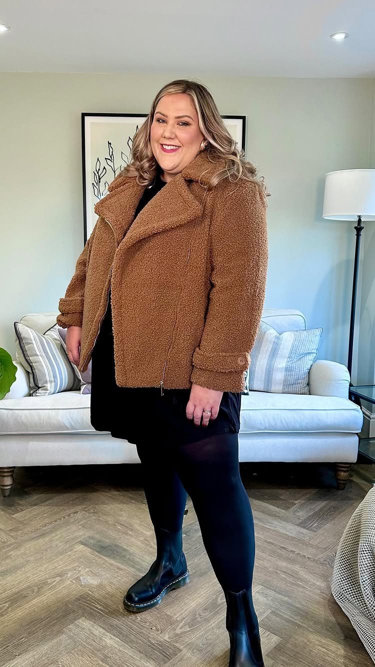 Plus Size Winter Outfits: 7 Cozy and Stylish Looks to Try 6 Plus size woman wearing a brown teddy coat, black dress, and black boots.