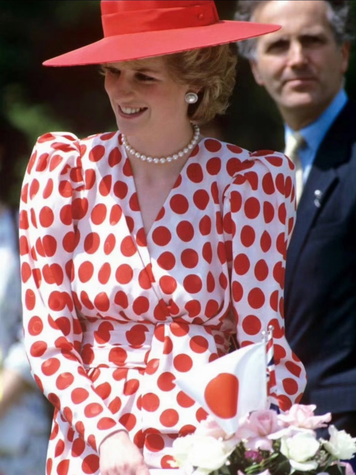 Princess Diana Outfits That Defined Royal Style (11 Ideas) 3 Princess Diana wearing a polka dot dress, red hat, and classic pearl jewelry.
