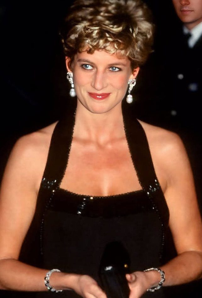 Princess Diana Outfits That Defined Royal Style (11 Ideas) 6 Princess Diana wearing a black sequined halter dress and pearl drop earrings.
