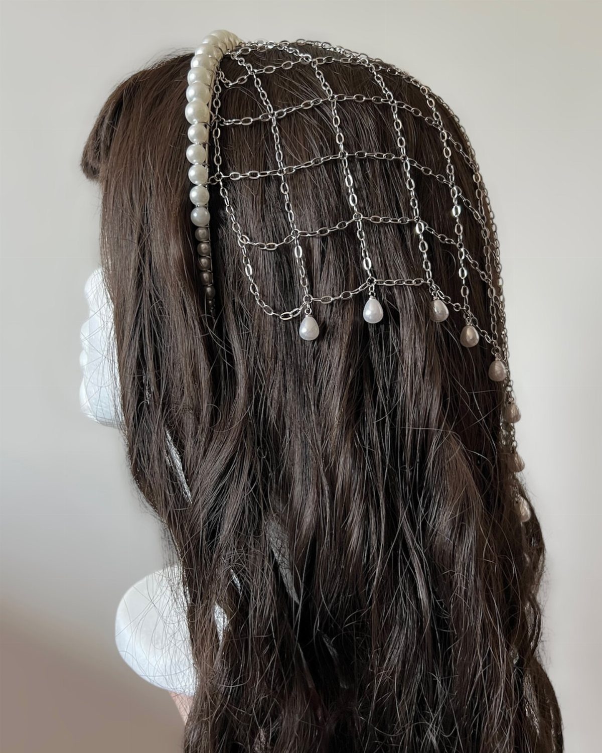 Renaissance Fair Outfits Women Can Wear: 12 Looks 10 Silver chain hairnet with pearls on a brown haired mannequin head.