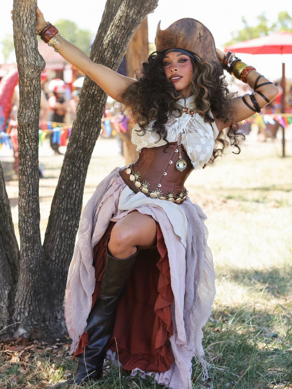 Renaissance Fair Outfits Women Can Wear: 12 Looks 9 Woman in a pirate frock with a tricorne hat, corset, and layered skirt.