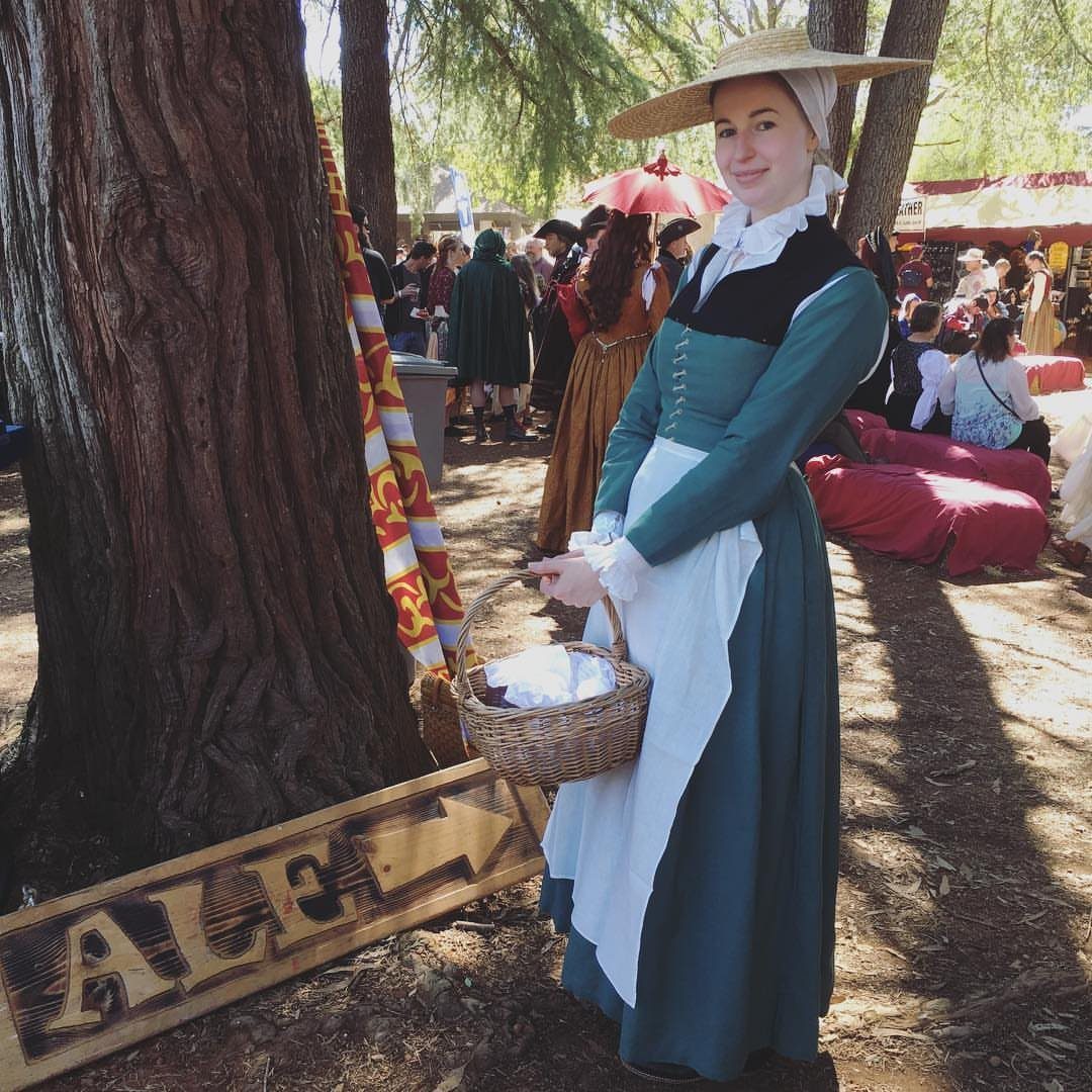 Renaissance Festival Outfits: 8 Ideas from Peasant to Princess 1 Woman in a teal peasant dress and straw hat holding a wicker basket.