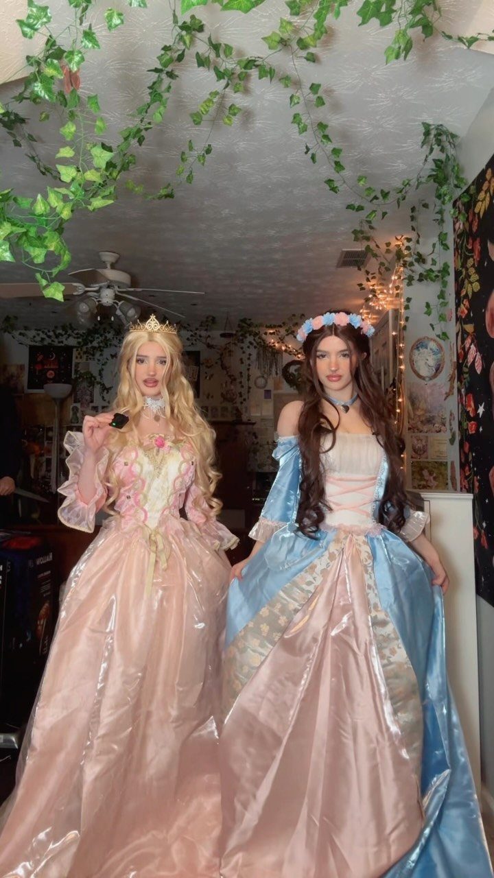Renaissance Festival Outfits: 8 Ideas from Peasant to Princess 7 Two women in regal pink and blue princess gowns wearing tiaras and floral crowns.