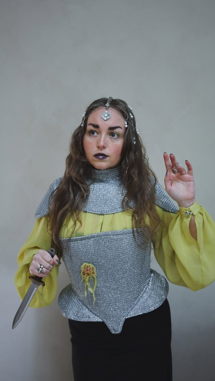 Renaissance Festival Outfits: 8 Ideas from Peasant to Princess 6 Woman in silver chainmail armor and yellow blouse holding a dagger
