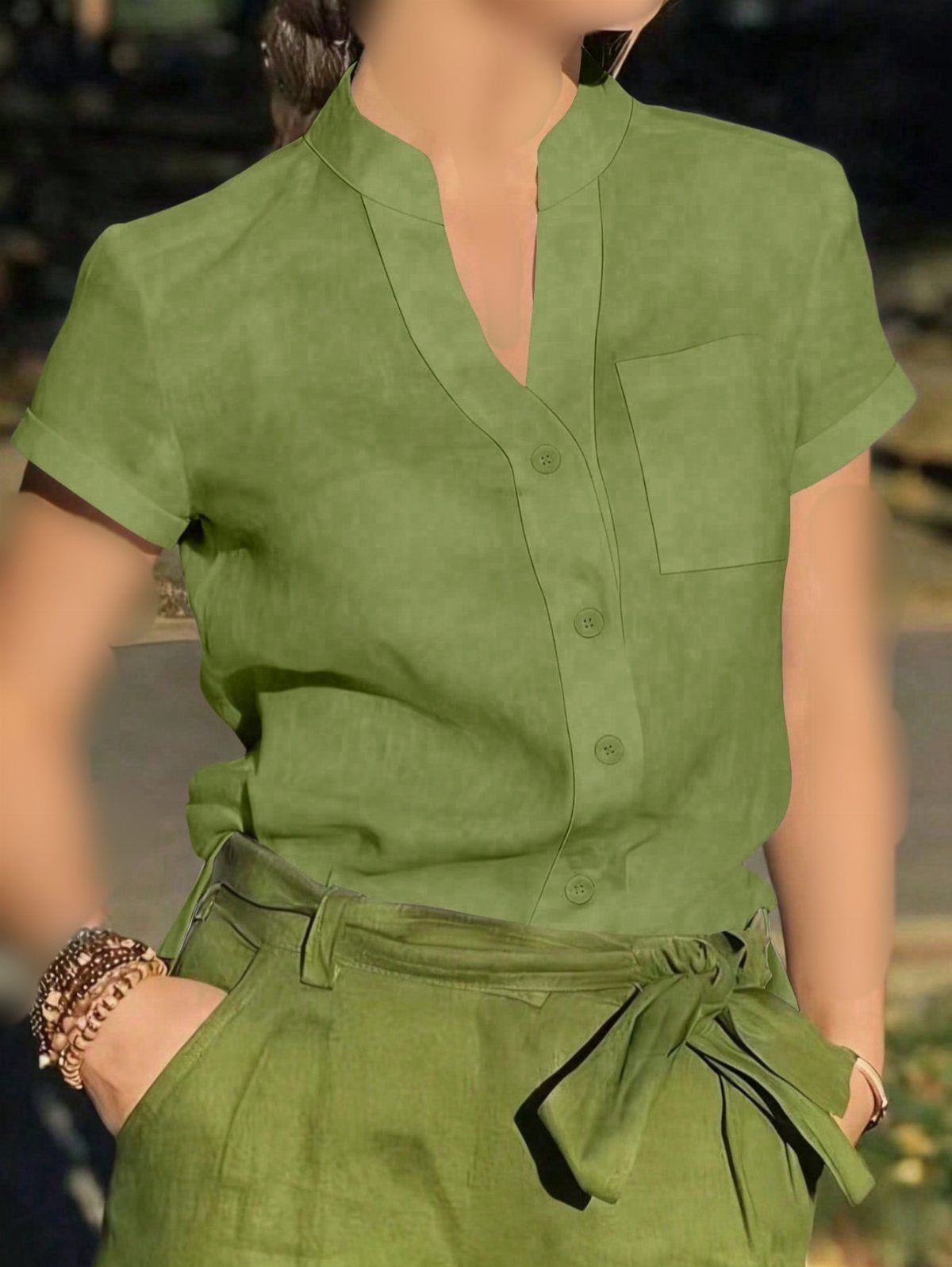 16 Short Torso Outfits That Balance Your Proportions 13 Person wearing a green linen short-sleeved shirt tucked into high-waisted green trousers.