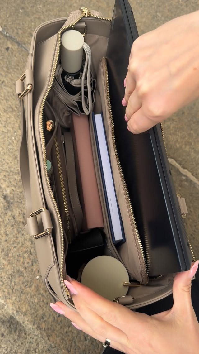12 Spring Work Outfits That Work From Desk to Dinner 7 Beige structured tote bag containing a laptop, notebooks, and a water bottle.