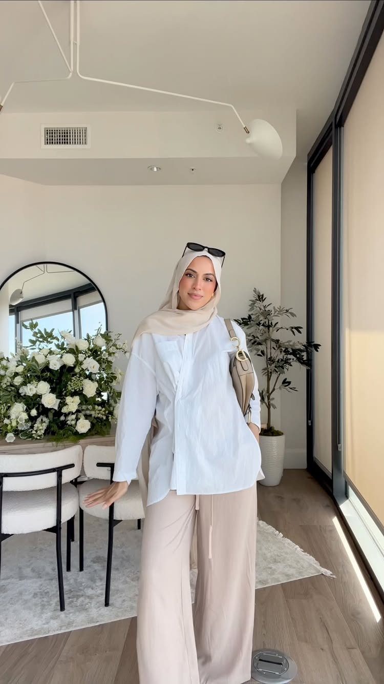 8 Summer Hijab Outfits for Modest, Breathable Style 2 Woman in a white tunic and wide leg beige trousers wearing a hijab.