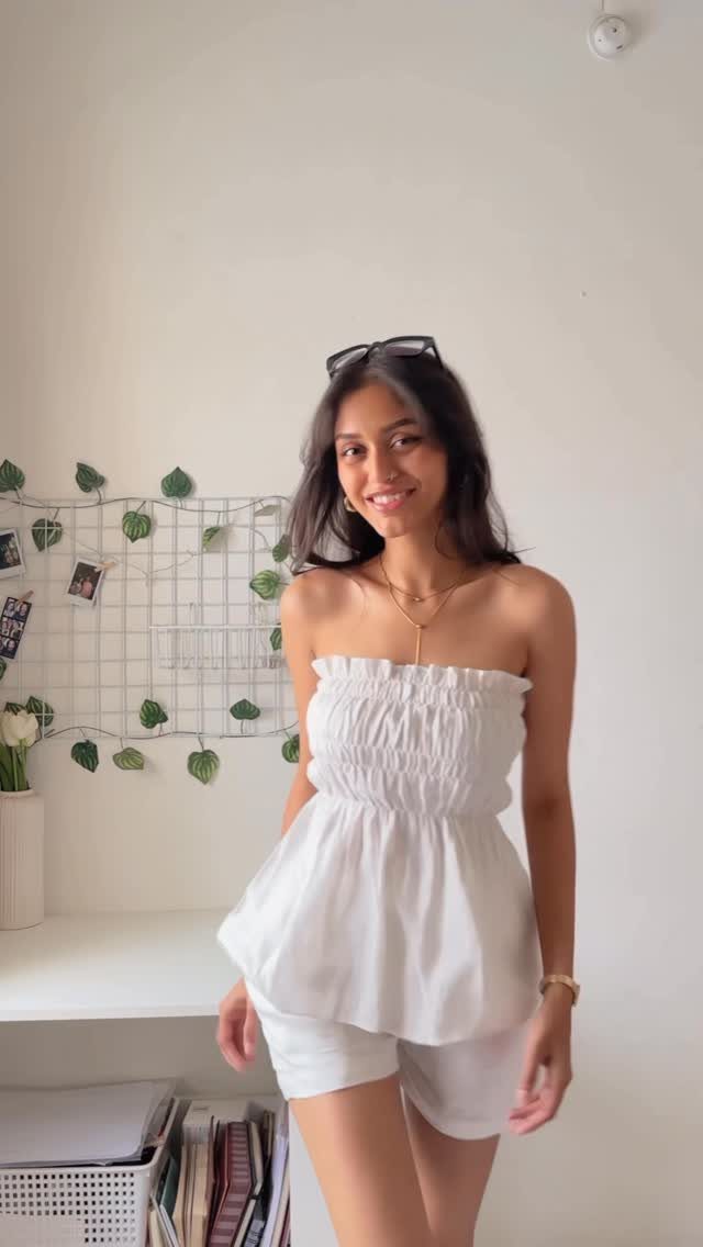 Summer House Outfits: 10 Effortless Ideas for Weekends Away 3 Woman wearing a white strapless matching set consisting of a top and shorts.