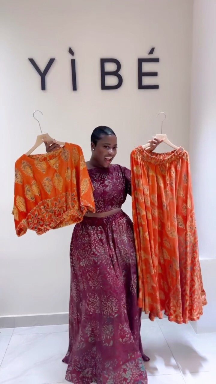 Summer House Outfits: 10 Effortless Ideas for Weekends Away 5 Woman wearing maroon floral two-piece set while holding orange floral matching set.