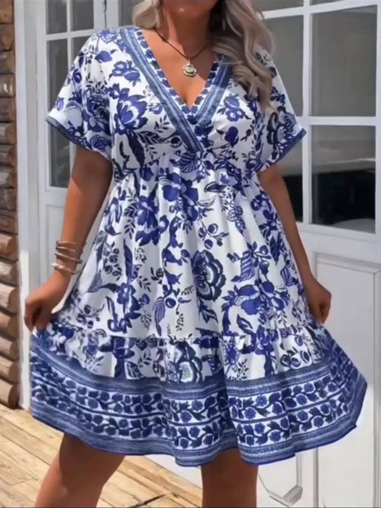 Tea Party Outfits for Adults: 10 Ideas from Garden to High Tea 2 Woman wearing a white and blue floral print short-sleeved dress on a deck.