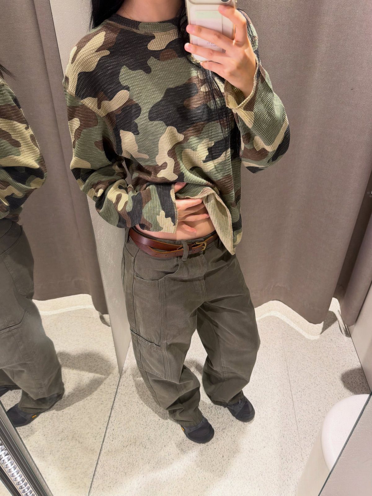 Twice This Is For Outfits: 6 Concert-Ready Looks to Recreate 1 Person wearing a camouflage print top and olive green cargo pants in a mirror