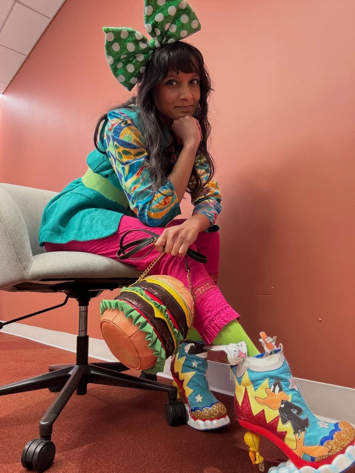 7 Wacky Wednesday Outfits for School, Work & Beyond 3 Woman in colorful eclectic clothing and cartoon boots holding a burger-shaped purse.