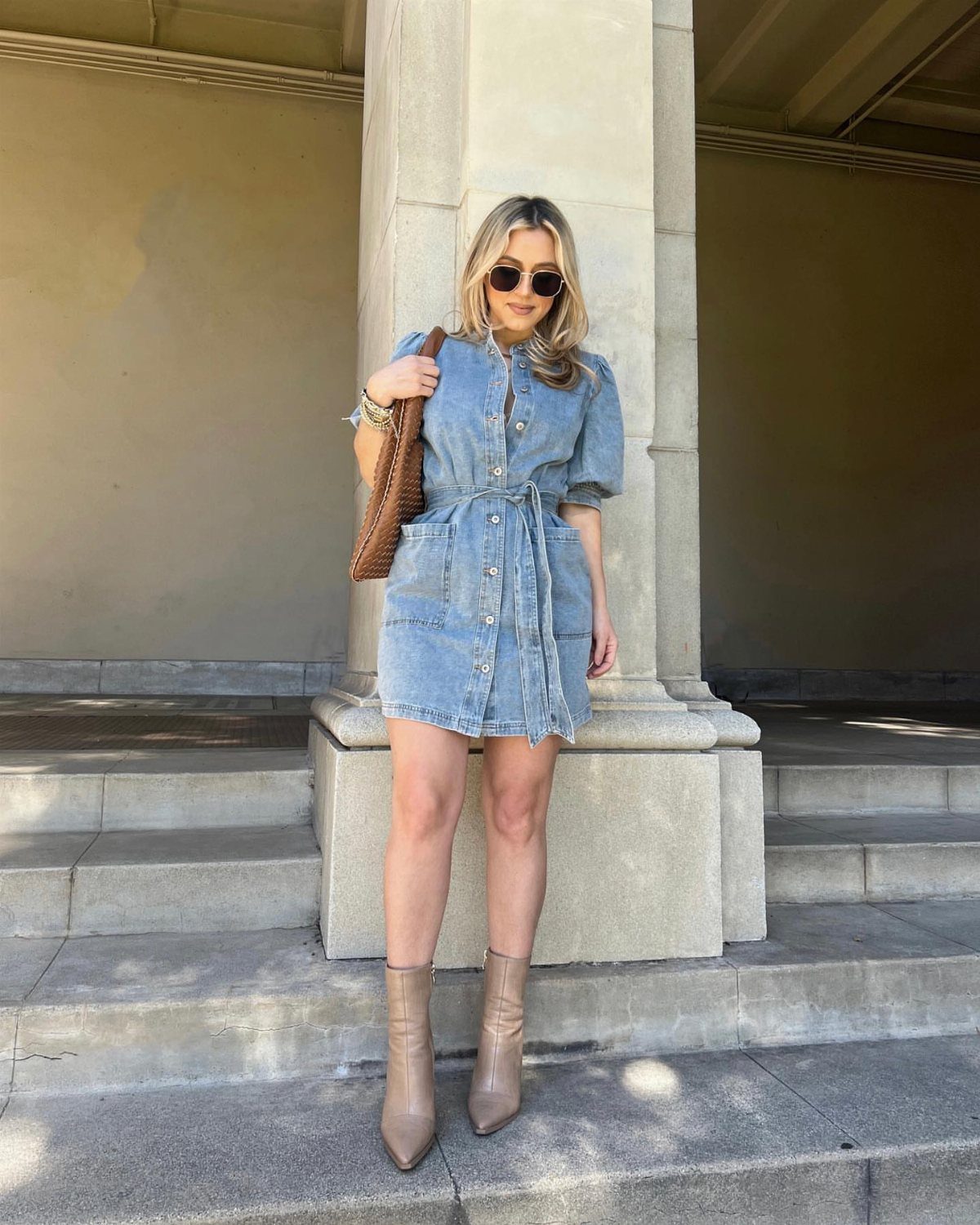 Walmart Spring Outfits: 10 Fresh Ideas for Women This Season 7 Woman in a light blue denim mini dress and tan ankle boots posing outdoors.